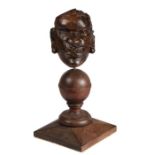 An early 17th century carved oak native African head appliqué, English Mounted on a sphere, and on