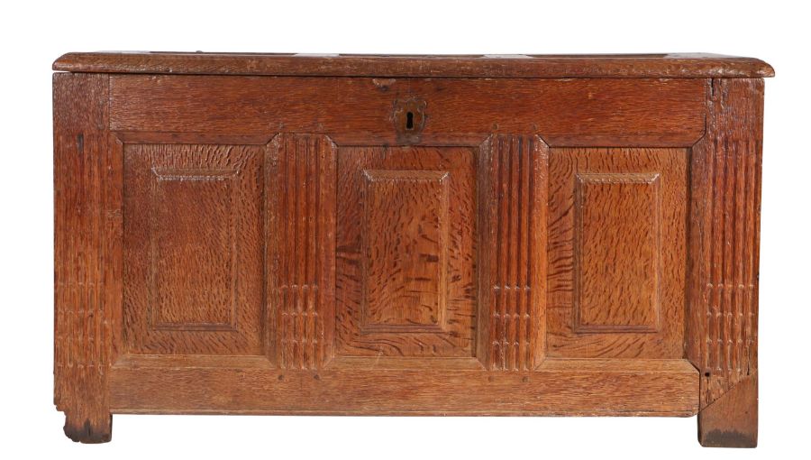 A 17th century oak coffer, German/Flemish The lid with three raised panels, and conforming front,