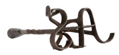A rare and unusual wrought iron ‘branding’ socket candlestick, circa 1800 The rolled and flared