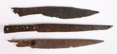 Three 15th-16th century excavated iron knives The first with a tapering blade and nagel guard,