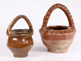 Two 17th century Dutch vessels The first with an arched handle above the tapering body, 22cm high,