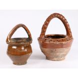 Two 17th century Dutch vessels The first with an arched handle above the tapering body, 22cm high,