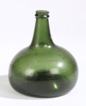 An early 18th century glass onion bottle, English, 1700-1720 Green glass, inverted pontil mark to