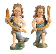 A pair of early 17th century polychrome figural candlesticks, Italian Each modelled as a standing