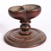 A 19th century treen dual salt and pepper Having paired dug-out compartments, on a turned stem and