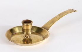 An early 18th century cast brass chamberstick, French, circa 1700-20 Having a socket with moulded
