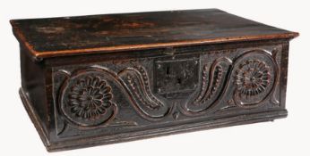 A Charles II oak board box, circa 1660 Having an impressive one-piece lid, the front carved with
