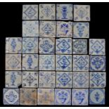 A collection of 18th century Dutch Delft tiles Each with a flower design, (32)