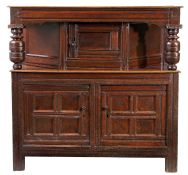 A Charles II oak joined court cupboard, Yorkshire, circa 1660 In the Elizabethan manner, having a