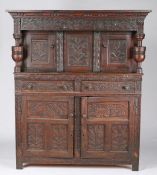 A 17th century oak court cupboard, circa 1670 and later Having a gauge-carved cornice, and foliate-
