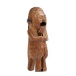 An 18th century treen figural nutcracker Designed with flowing mid length hair,  almond eyes and