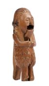 An 18th century treen figural nutcracker Designed with flowing mid length hair,  almond eyes and