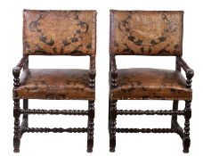 A pair of mid-17th century walnut framed and leather upholstered open armchairs, Flemish Each with a