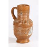 A Raeren late 16th/early 17th century stoneware jug With a ribbed neck above portrait medallions,