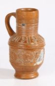 A Raeren late 16th/early 17th century stoneware jug With a ribbed neck above portrait medallions,