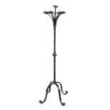 A wrought iron floor standing candelabra, French, circa 1700 Having a central pricket, on a twist-