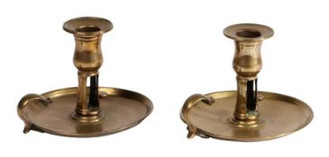 A near pair of George III cast brass chambersticks, circa 1780 Each with tulip-shaped socket with
