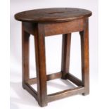 A George III oak stool, circa 1760 Having an oval top with ’S’-shaped cut-out to centre, on gently