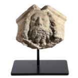 A carved stone head Depicting a bearded figure with flowing hair, possibly Neptune, 33cm wide, 24.