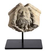 A carved stone head Depicting a bearded figure with flowing hair, possibly Neptune, 33cm wide, 24.