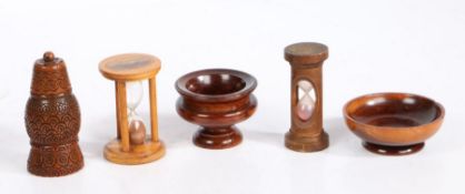 A collection of treen To include two sand glasses, a coquilla pepperette and two lignum-vitae salts,