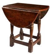 An early 17th century oak joint stool-table, with an early 18th century elm top, English The elm