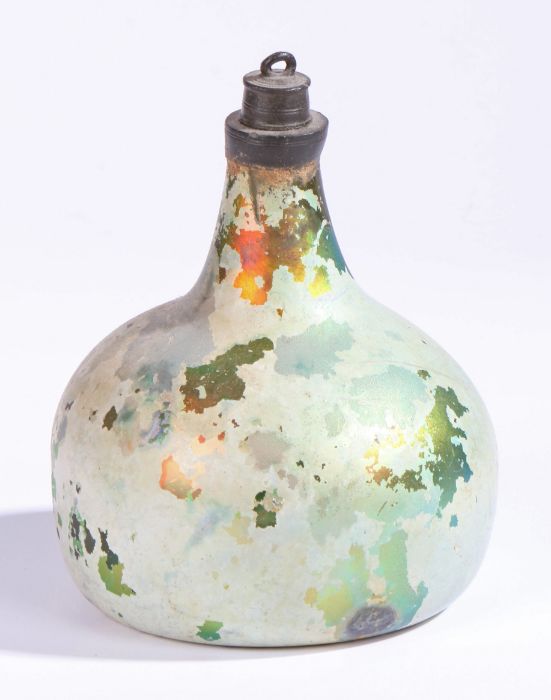 An early 18th century glass onion bottle, English, 1700-1720 Green glass with lustre, inverted