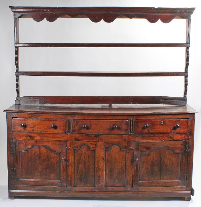 A George II oak fully-enclosed dresser base with open rack, circa 1750 The associated rack with