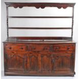 A George II oak fully-enclosed dresser base with open rack, circa 1750 The associated rack with