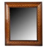 A 19th century walnut and marquetry-inlaid cushion-moulded mirror The rectangular plate within a