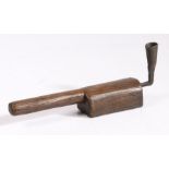 An oak and wrought-iron hand-held socket candlestick The socket formed from rolled iron, attached to