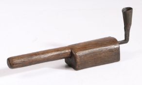 An oak and wrought-iron hand-held socket candlestick The socket formed from rolled iron, attached to