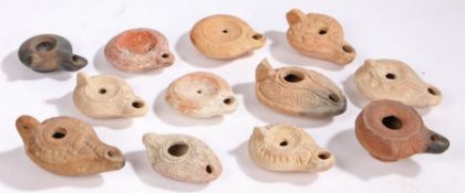 A collection of oil lamps, to include Mainly Roman examples, various designs, a mask example,