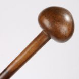 A Southern African knobkerrie, the domed head above a long shaft, 77cm long
