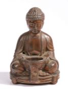 A metal Buddha, seated position holding a bowl, 15cm high