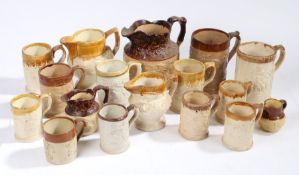 A collection of 19th Century pottery mugs, various designs with treacle glaze rims, to include