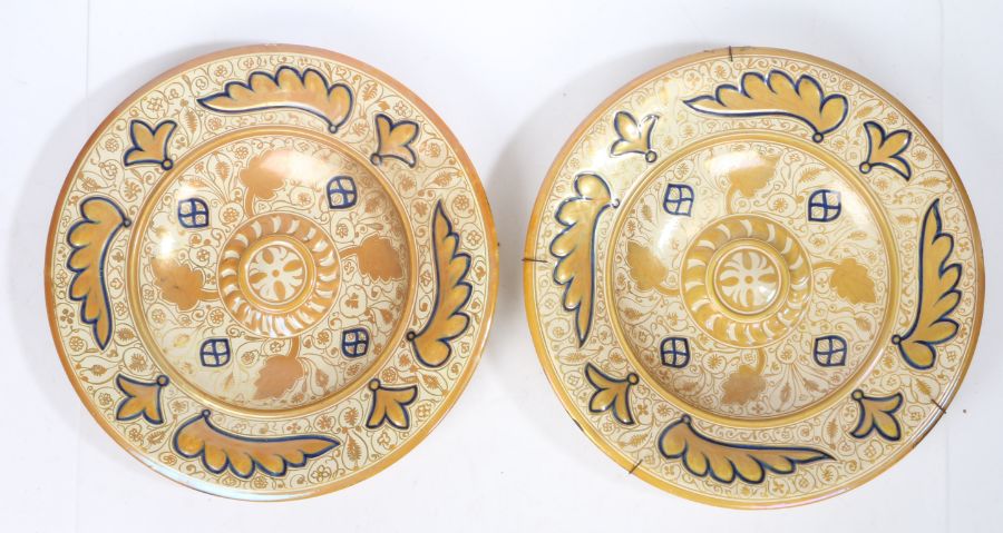 Pair of late 19th century Hispano-Moorish pottery lustre chargers, each with wide borders of