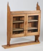 Country pine hanging wall cabinet, having a pair of glazed doors enclosing three shelves, with later
