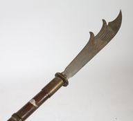 An ornamental Fauchard type polearm weapon, the steel blade above a turd wooden handle, 216cm long