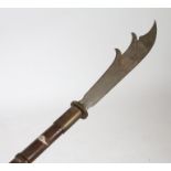An ornamental Fauchard type polearm weapon, the steel blade above a turd wooden handle, 216cm long