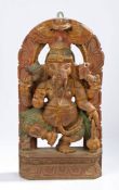 An Indian carved deity panel, depicting Ganesh, traced of polychrome decoration remaining, 46cm