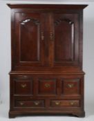 Late 18th century oak linen press cupboard, the pair of panelled doors enclosing an interior with