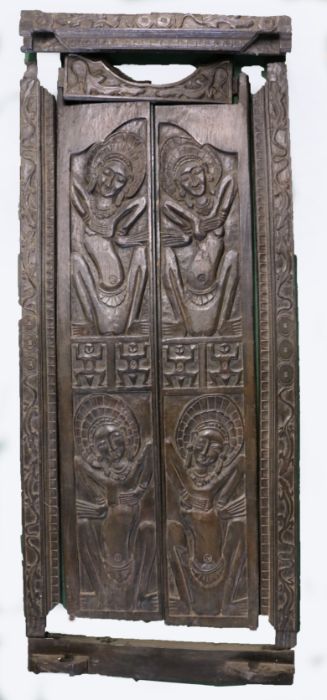 A pair of Indonesian hardwood doors and frame, the pediment with carved lizards and roundels, the