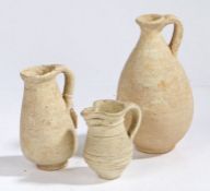 A Hellenistic pottery jug, circa 3rd Century BC, together with a Roman flagon, 3rd Century AD, and a
