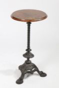 Victorian cast iron based table, having circular mahogany top above an ornate base with barley twist
