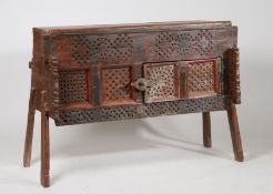 Indian dowry chest, 20th century, having a single hinged door and sliding door with carved