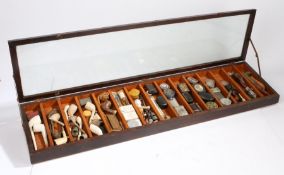 Early 20th century shops table top display cabinet with contents of clay pipes, 19th century snuff