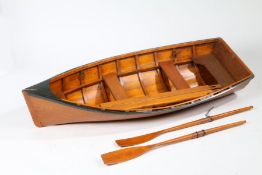 Small model teak effect boat, with oars, 135cm long