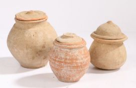 Three Roman lidded pots, 1st - 3rd Century AD, 12cm to 15cm high, (3)