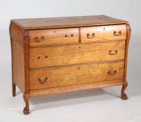 Continental oak bombe chest, fitted three long graduating drawers and raised on paw feet, 116cm